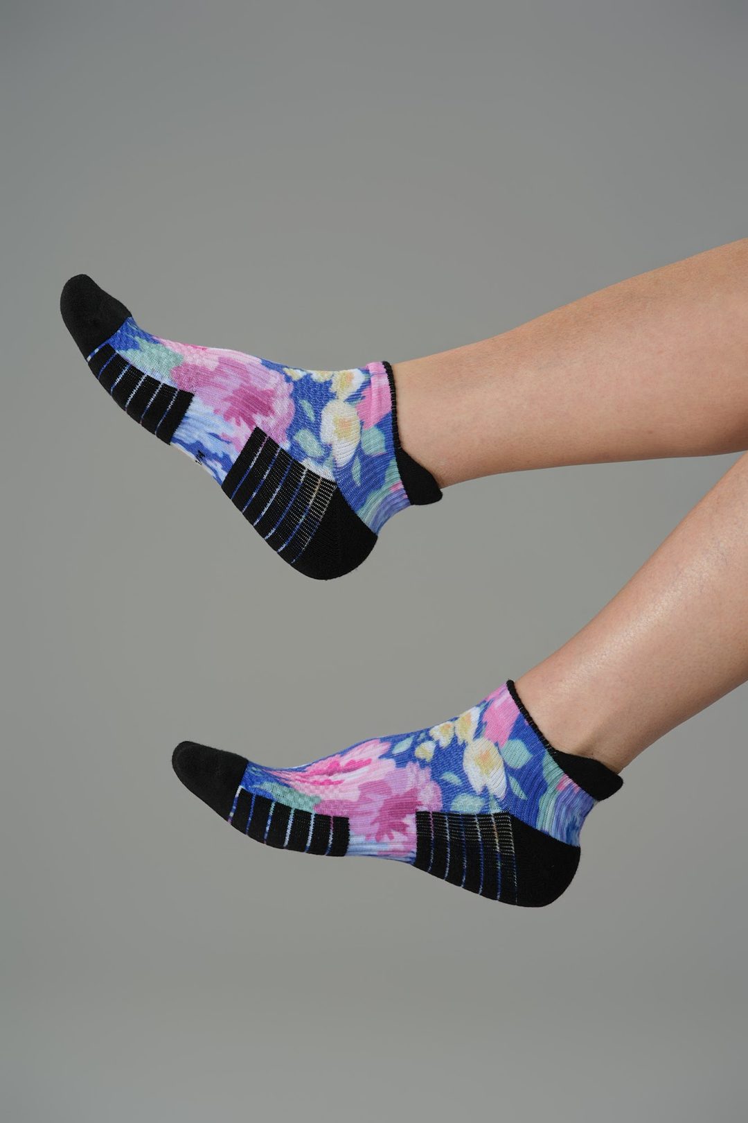 Legs raised in floral Viasox ankle compression socks