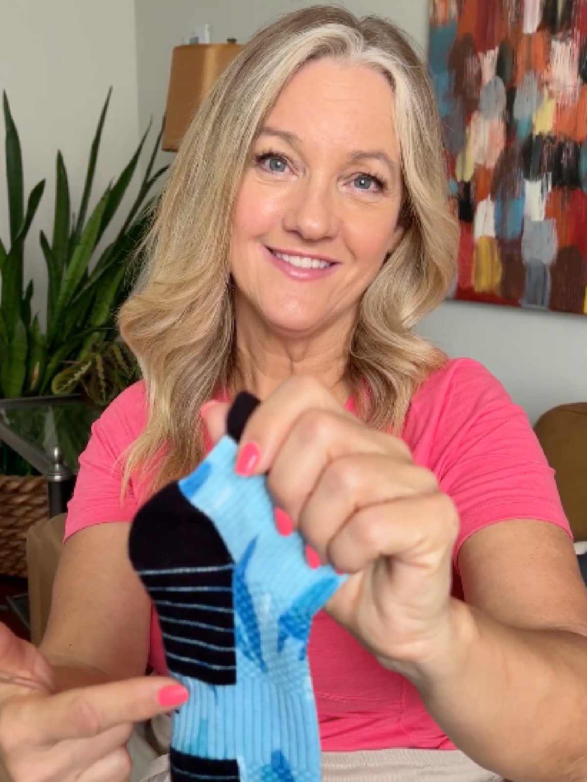Woman showing an Ankle Compression sock before putting it on